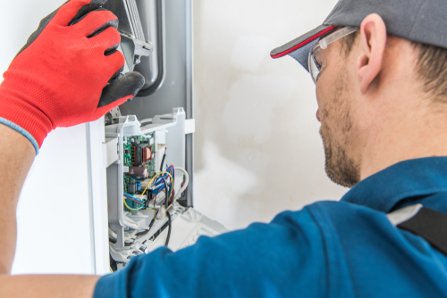 Technician,servicing,residential,heating,equipment.,central,heat,gas,furnace,issue.